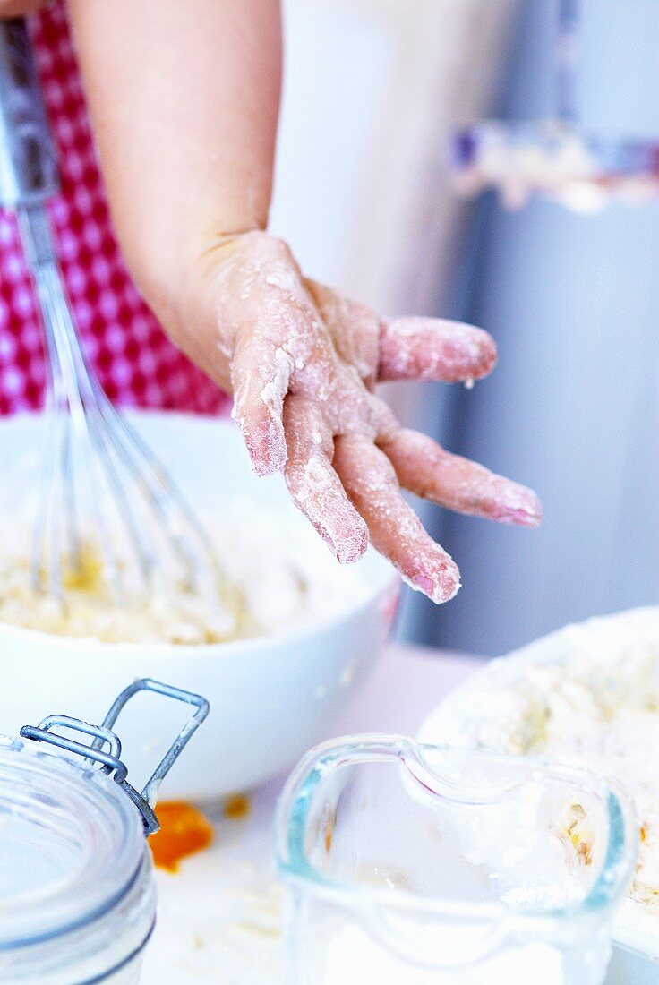 Child's hand covered in dough
