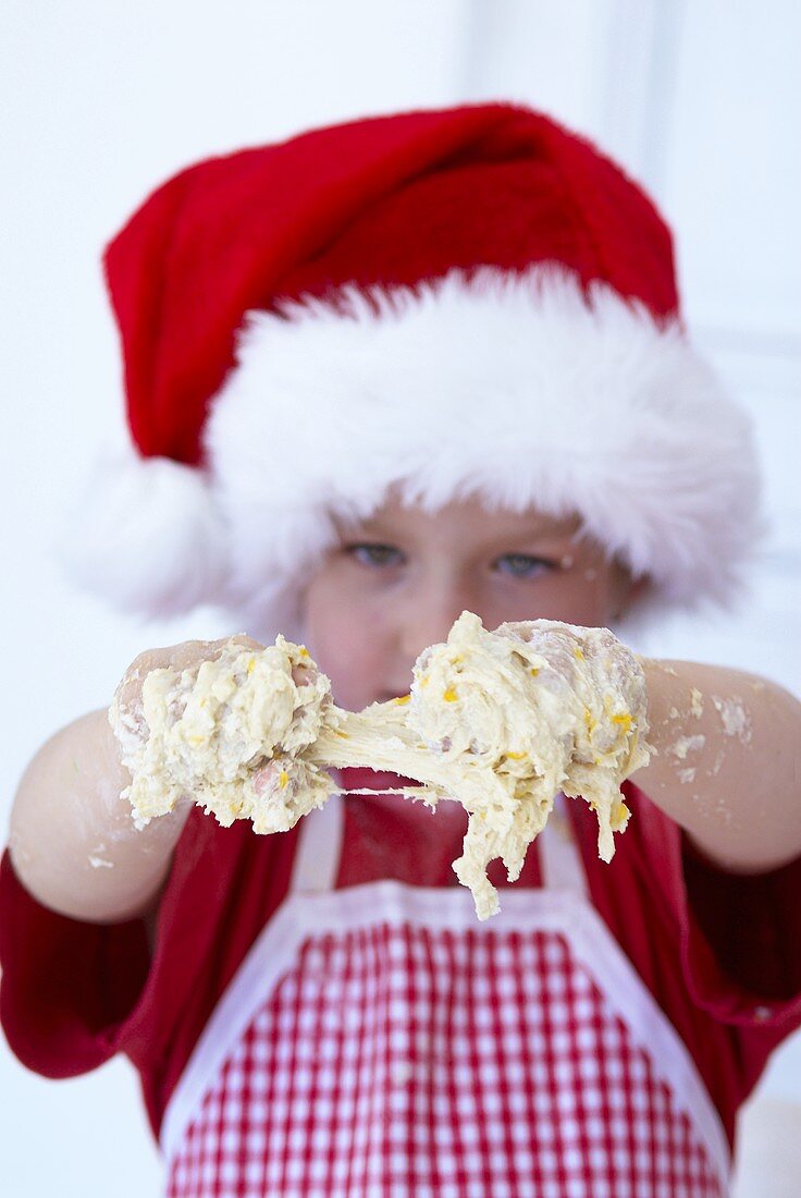 'Young baker' with her hands covered in dough