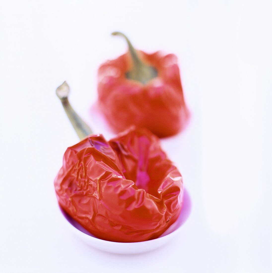 Two baked peppers in small dishes