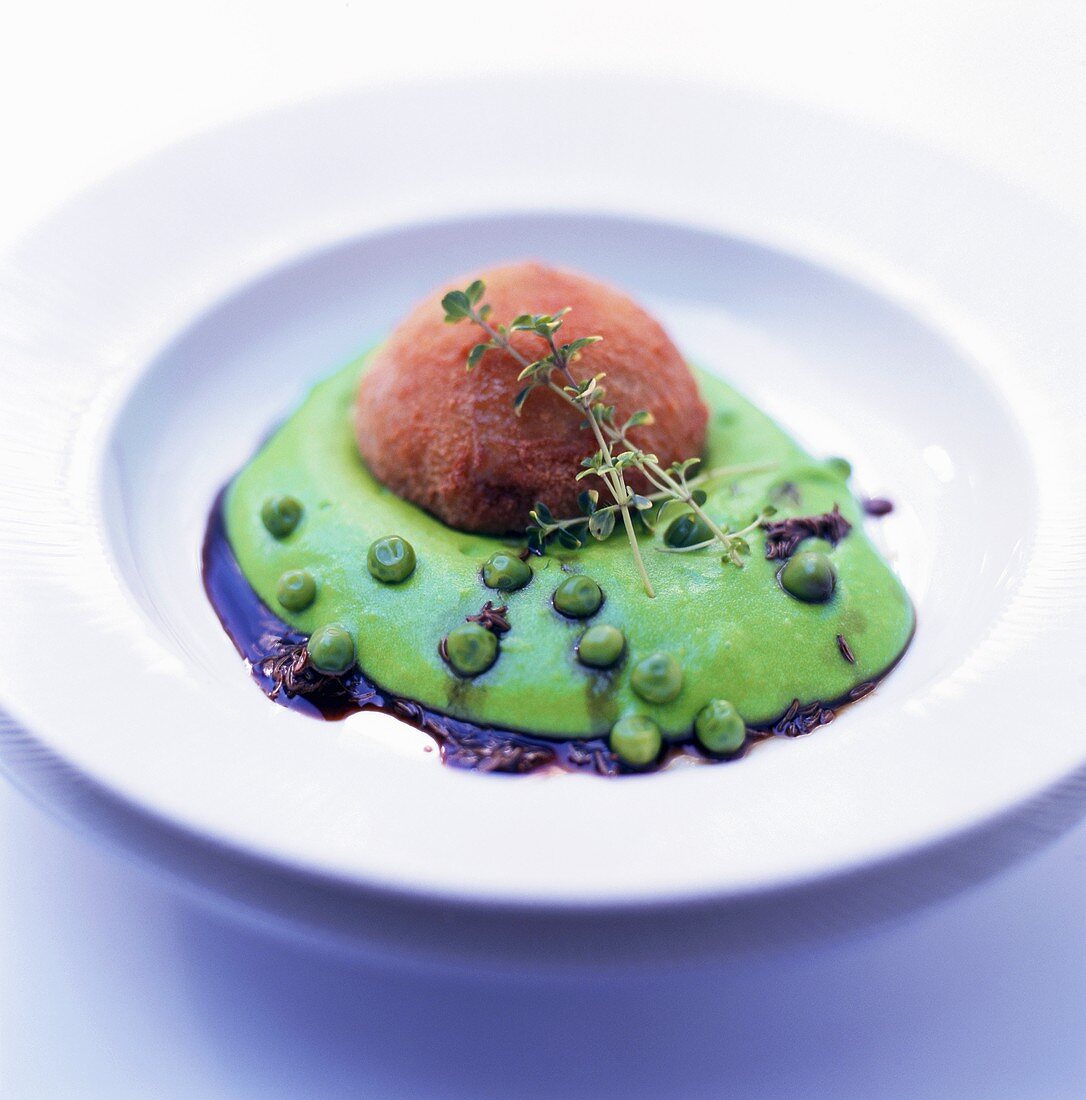 Minced pig's trotter on pea puree with Kümmel sauce