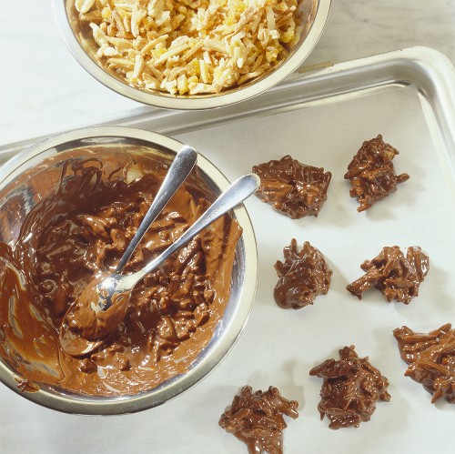 Chocolate almond clusters and ingredients on baking tray