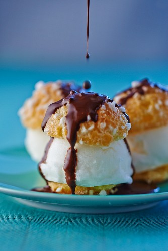 Choux pastries filled with lemon ice cream and topped with chocolate glaze