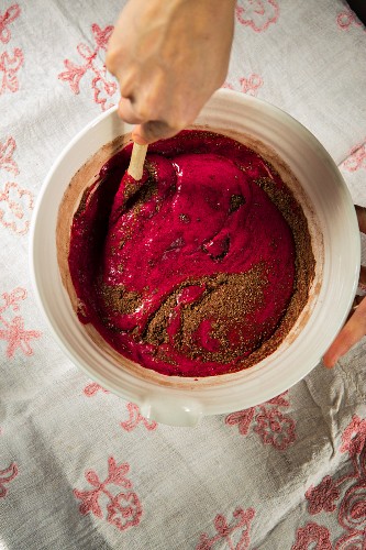 Mixing blended roasted beetroot and organic cocoa powder