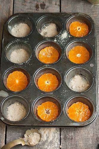 Preparing upside-down orange cakes