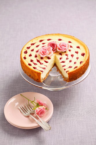Cheesecake with raspberry sauce and rose decorations