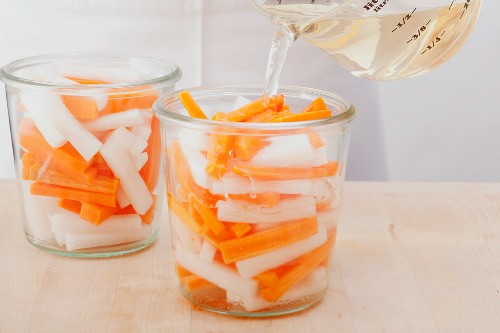 Radishes and carrots being pickled Vietnamese style