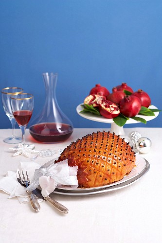 Roast ham studded with cloves and glazed with pomegranate syrup