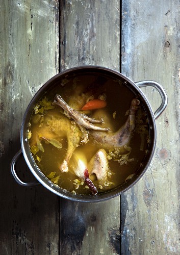 Chicken soup with carrots in a saucepan
