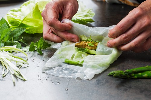 Vegan rice paper rolls with tofu and asparagus being made