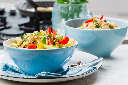 Vegan couscous salad with colourful fried vegetables and parsley