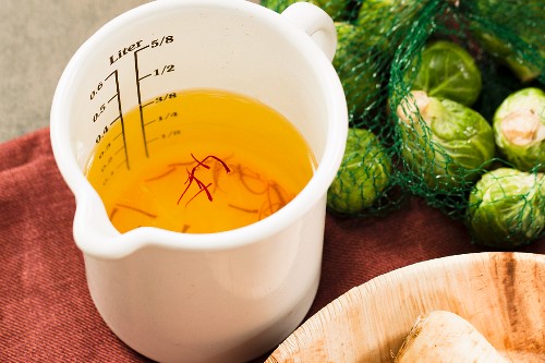 Vegetable broth coloured with saffron threads