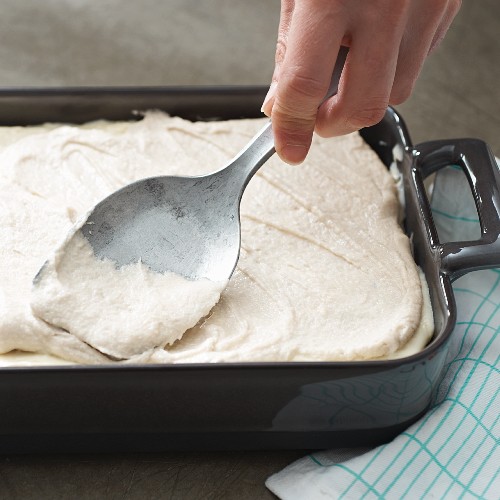 A bake being spread with cashew cheese