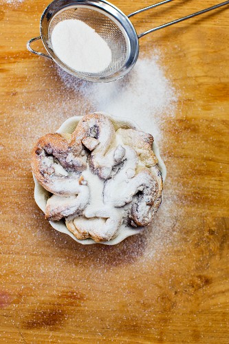 A blueberry pastry dusted with icing sugar