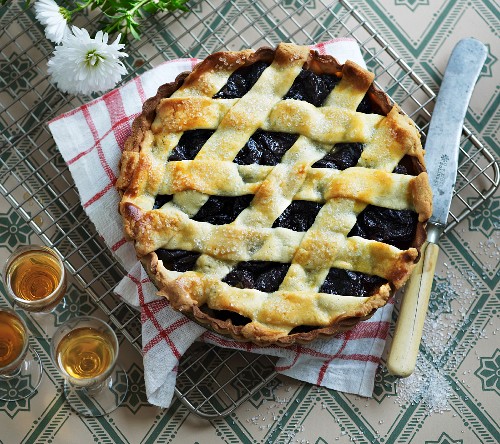 A fruit tart with dried plums and a lattice top