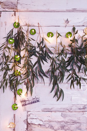 A garland made from ice cup cases, fairy lights and eucalyptus sprigs