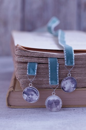 Homemade bookmarks with family photos on velvet ribbons