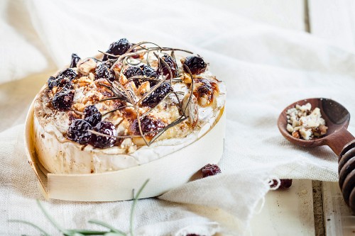 Baked Camembert with nuts, cranberries, rosemary and honey