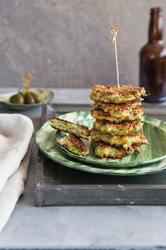 A stack of broccoli fritters with capers
