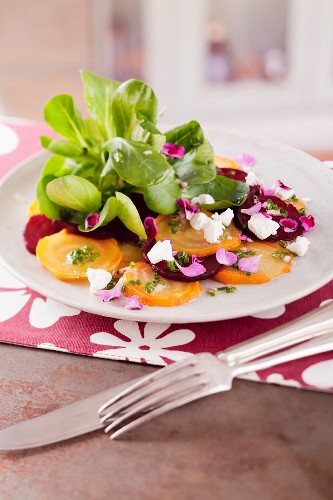 Carpaccio of red and yellow beetroot with lamb's lettuce and goat cheese