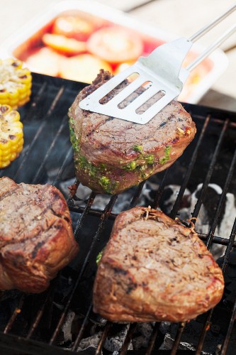 Fillet steaks stuffed with pesto on barbecue