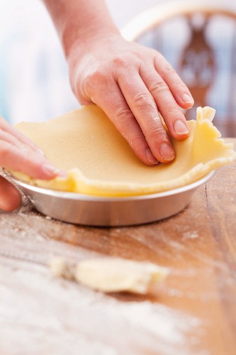 Lining a pie tin with shortcrust pastry