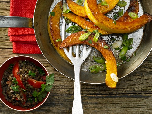 Roasted pumpkin wedges with tomatoes and lentils