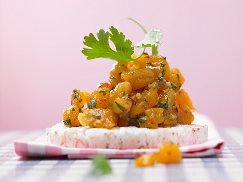 Apricot chutney on a rice cake with ginger and chilli