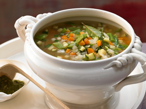 A bowl of French vegetable soup with tomato and basil pesto