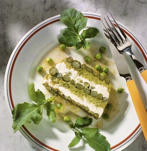 A slice of spring terrine with asparagus, peas & cream cheese