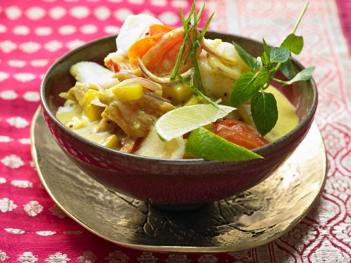 Fish and coconut curry with mango, tomatoes and aromatic spices