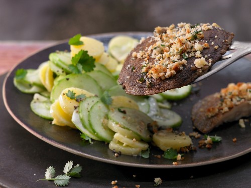 Grilled portobello mushroom schnitzel with a cucumber and potato salad