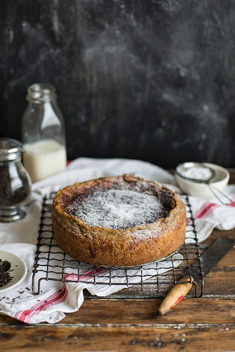 Dairy cake with icing sugar on a cooling rack