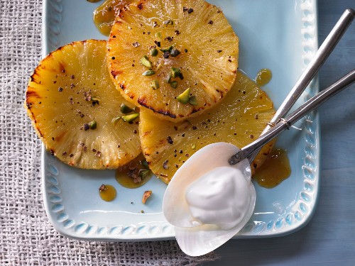 Grilled pineapple with pimento sugar and orange syrup