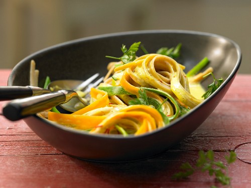 Colourful vegetable noodles with saffron sauce