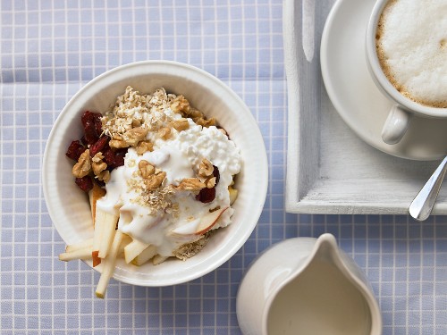 Oatmeal with fruit, nuts and fresh cheese