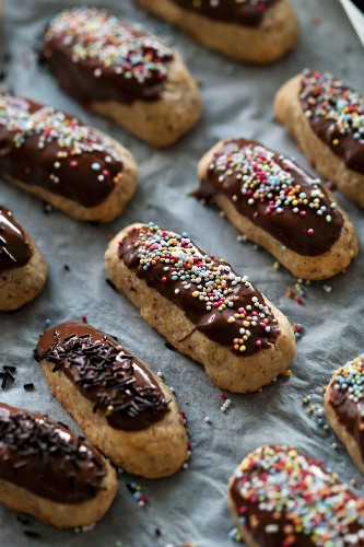 Almond and chocolate cookies with sprinkles on a baking tray