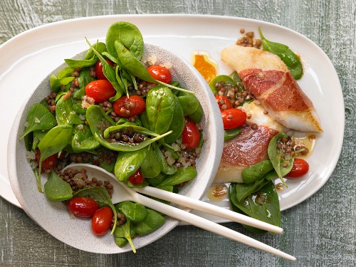 Spinach salad with lentils and zander wrapped in parma ham