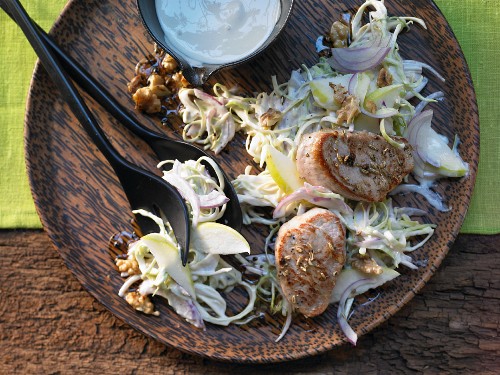 A Waldorf cabbage salad with pork fillets