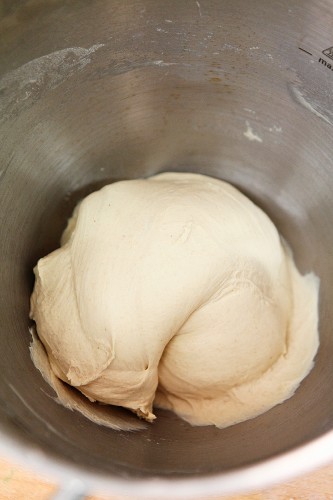 Machine-kneaded dough in a metal bowl