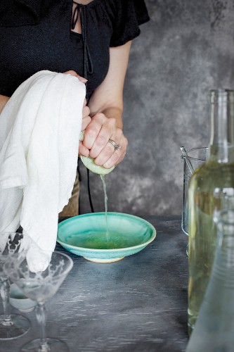 A women is preparing a matcha wine cocktail