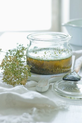 Homemade herb oil in a glass