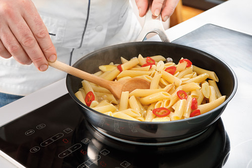 Pre-cooked pasta in pan with chili