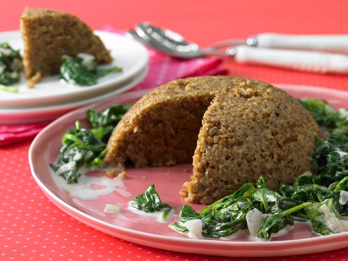 Almond nut roast on a bed of leaf spinach