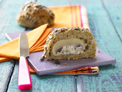 A multi-grain bread roll with a stuffed mushroom