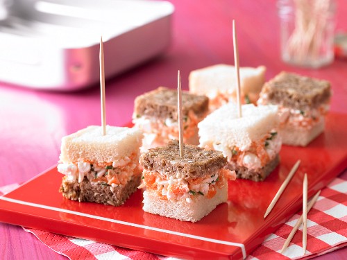 Brown and white sandwiches with cream cheese and carrots