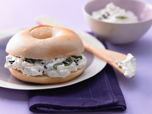 A sheep's cheese bagel with mint and cumin