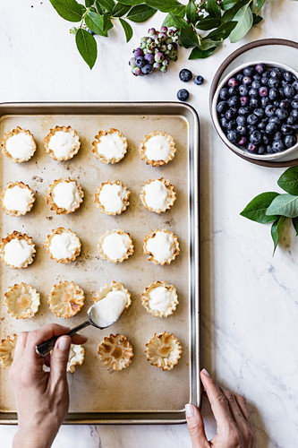 Mini Blueberry Lemon tarts is getting filled