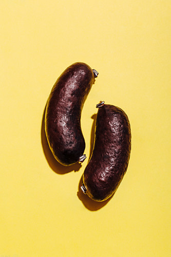 Black pudding on a yellow background