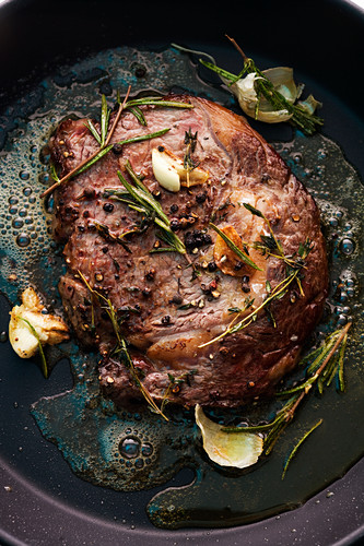 Seared beef steak with garlic, spices and rosemary