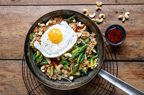 Fried rice with green asparagus, cashew nuts and fried egg